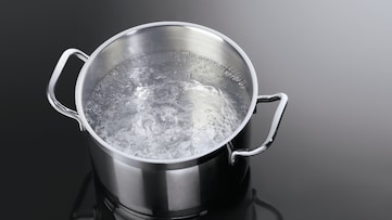 Boiling water in a pot on a hob